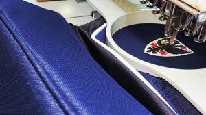 An image of the AFC Wimbledon logo being embroidered onto a bag